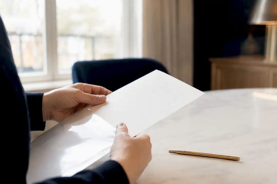 Hands opening insurance policy document sleeve
